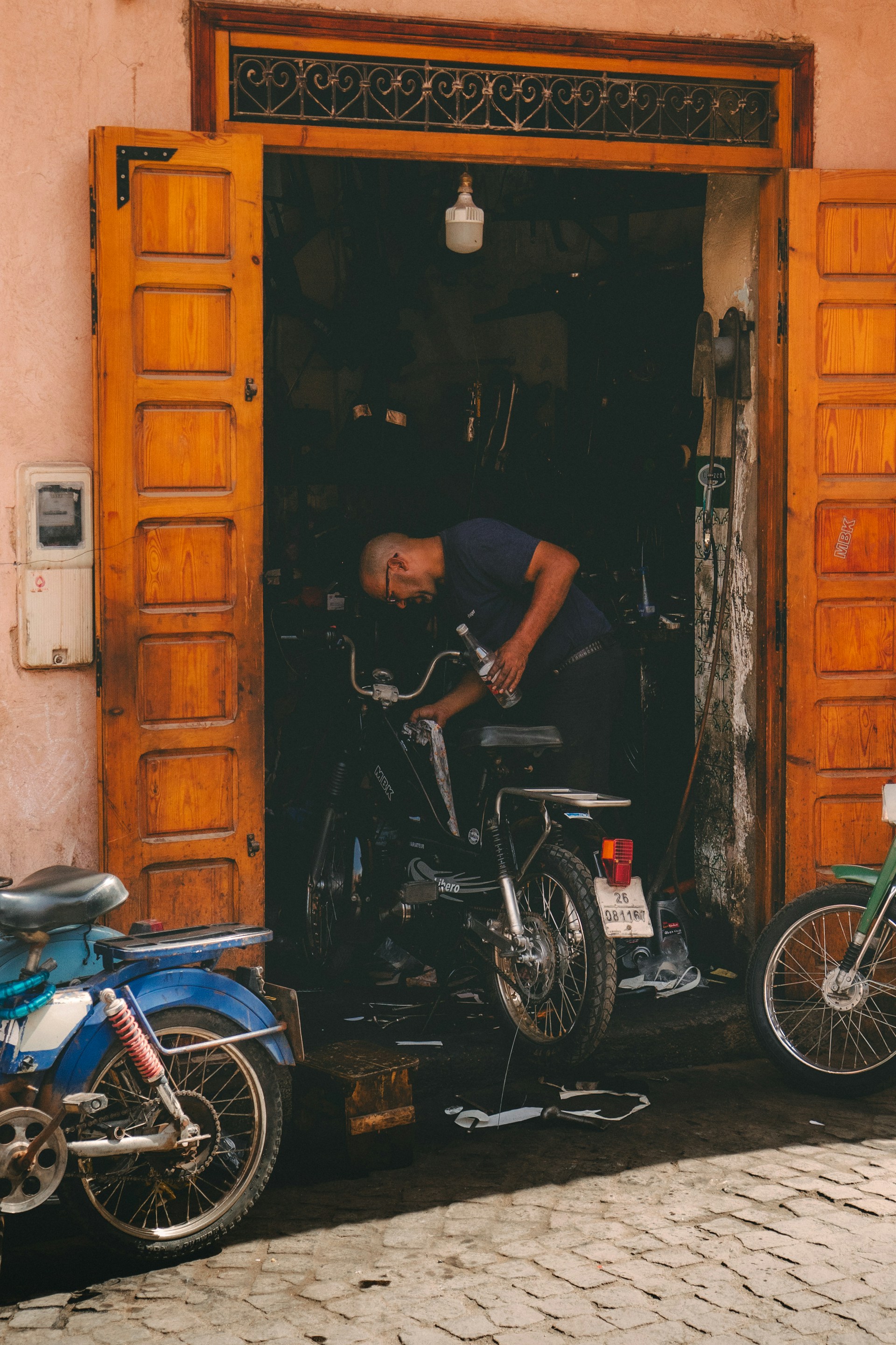Motorcycle mechanic at work — Rev and Ride workshop, Kapan, Kathmandu